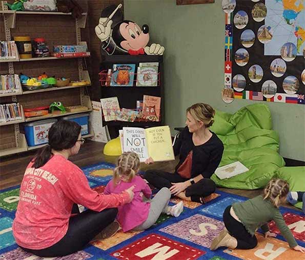 children having a book read to them